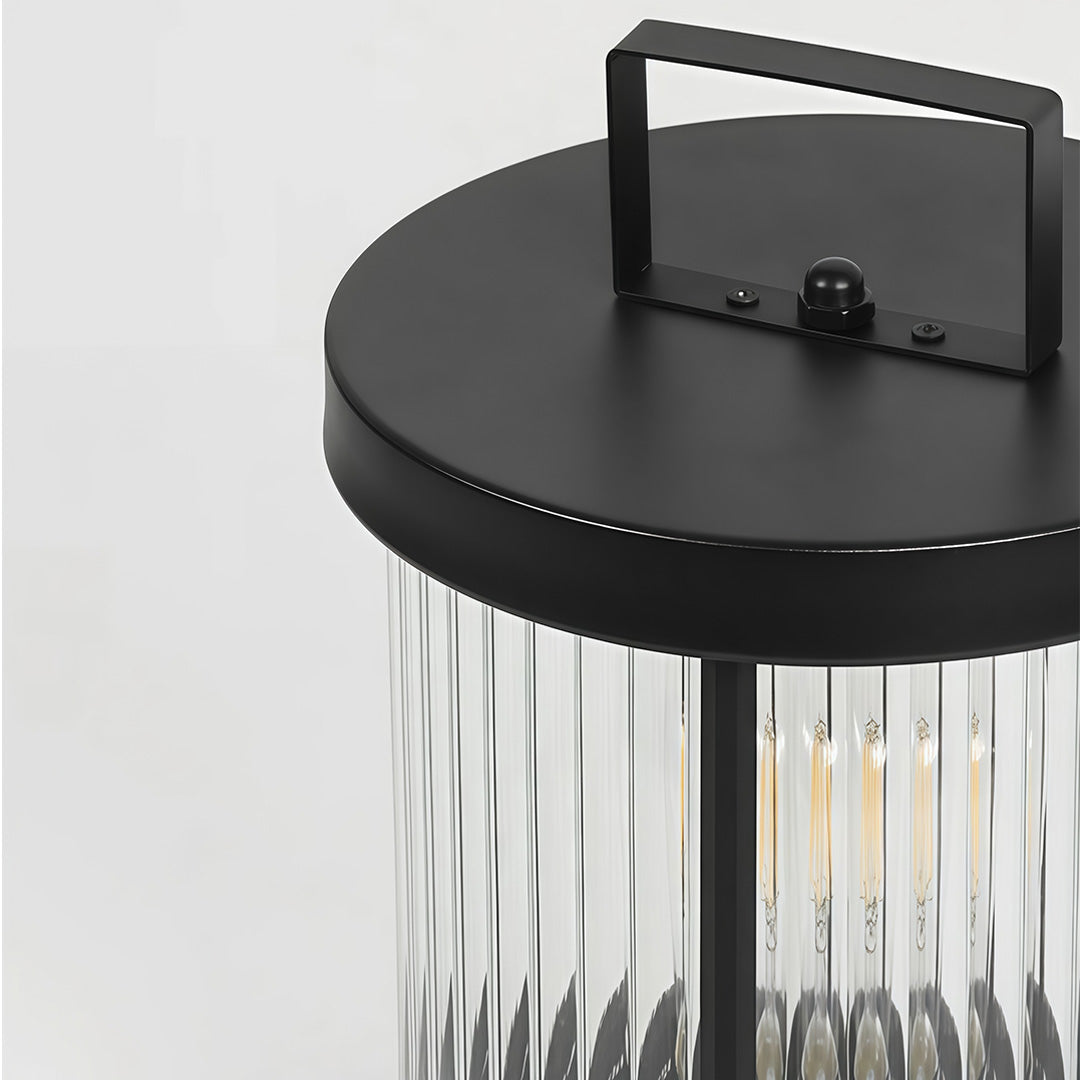 Close-up of an LED solar lantern, showcasing its clear glass design and warm light.