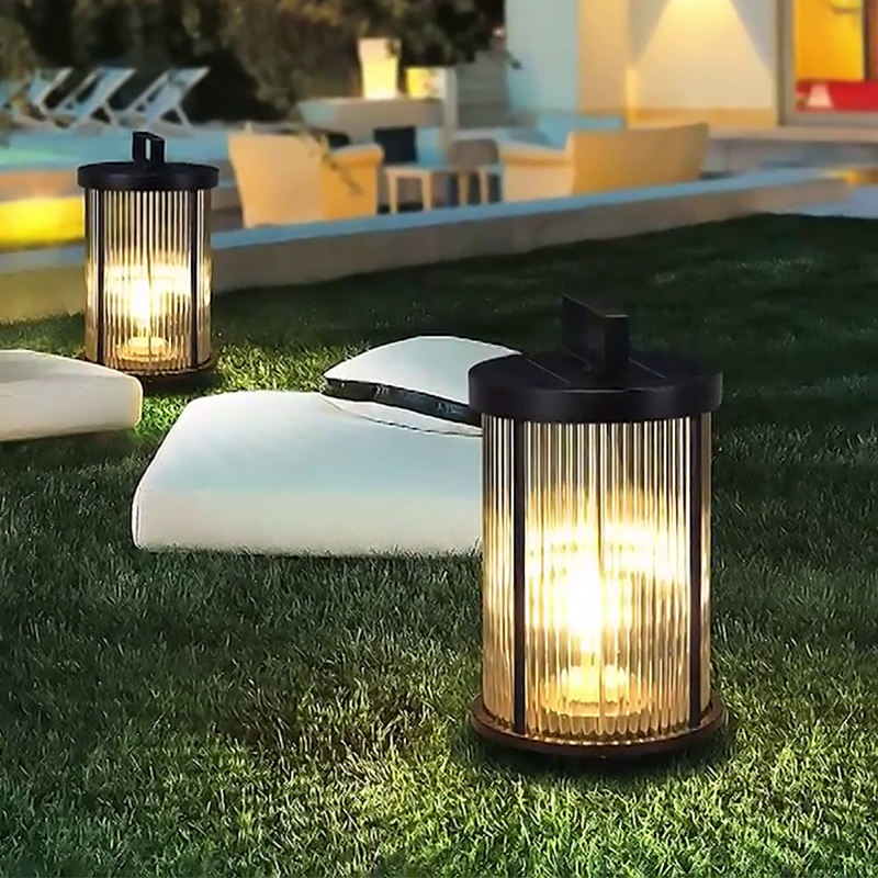 LED solar lantern with a cylindrical design, illuminating a garden area with soft, warm light.