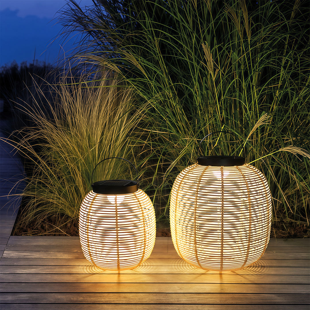 LED solar lanterns arranged on a patio, offering outdoor lighting with an elegant, natural design.
