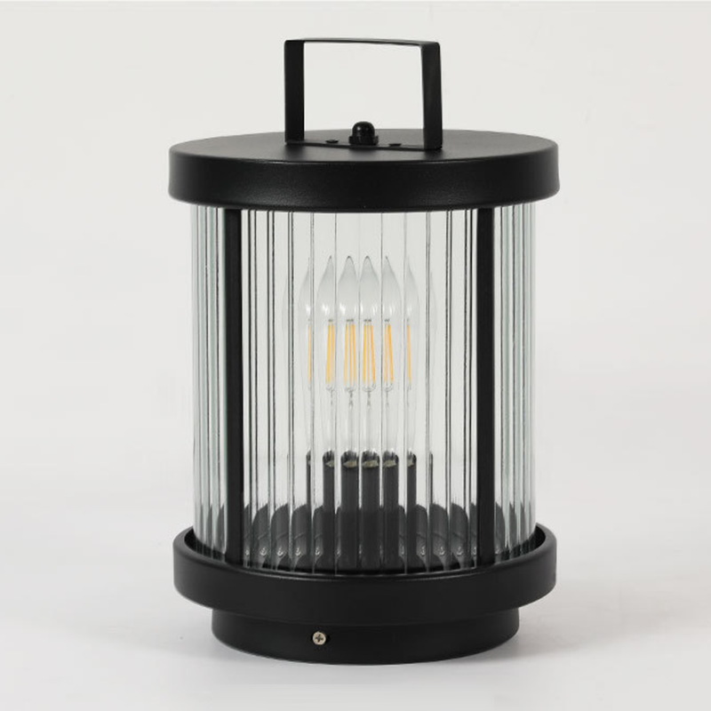 LED solar lanterns outdoor with a black metal frame, casting a warm glow on an outdoor table setting.