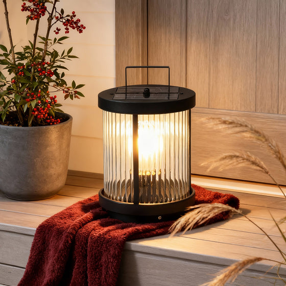 LED solar lanterns outdoor for outdoor use, providing warm illumination on a cozy patio with potted plants.