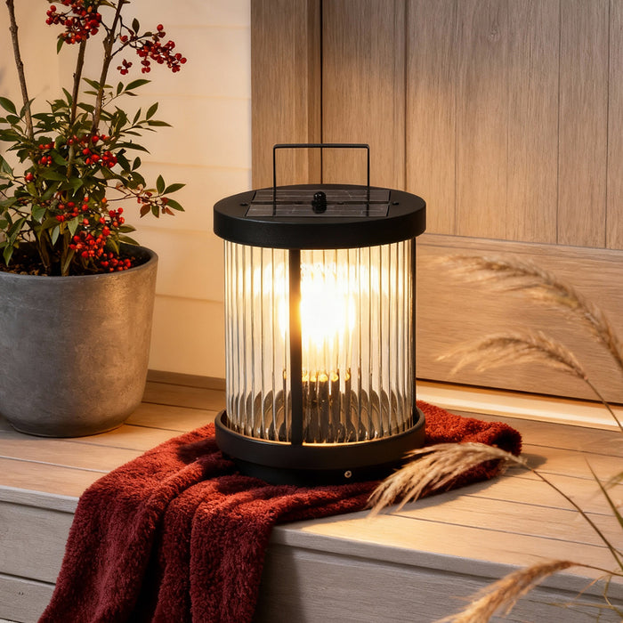 LED solar lanterns outdoor for outdoor use, providing warm illumination on a cozy patio with potted plants.