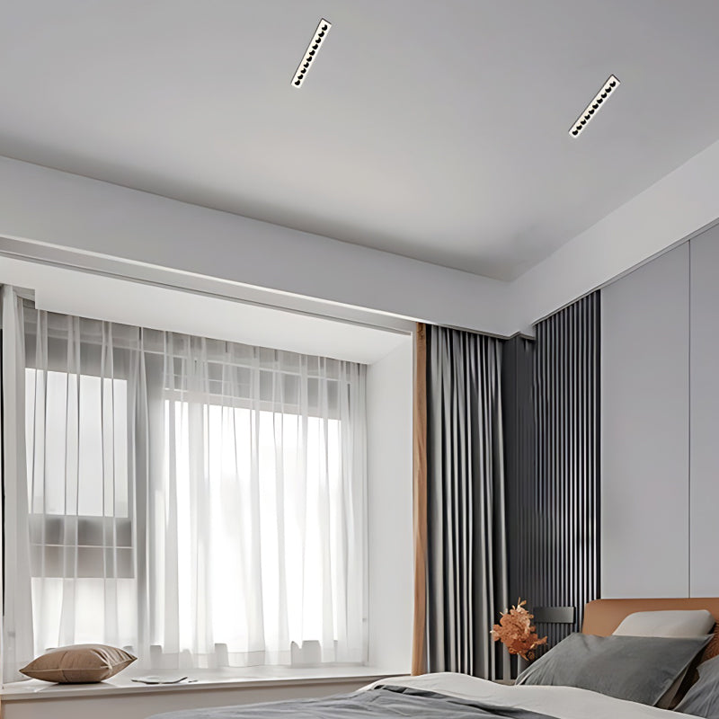 LED spotlights bulbs installed in a sleek track lighting system in a living room.