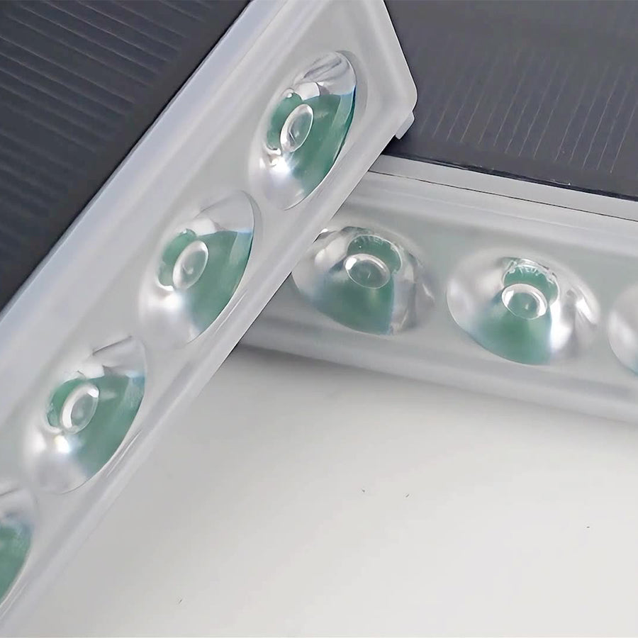 Close-up installation view showing LED step lights mounted in white wall surface with green indicator lights