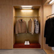 LED strip ceiling lights illuminating a modern wine cabinet and shelving display with warm integrated lighting.