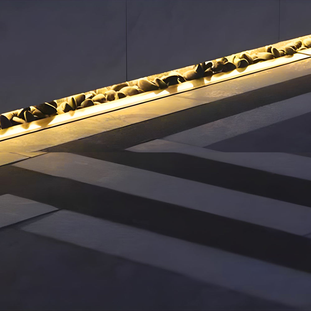Close-up view of LED strip lights installed in aluminum channels creating uniform linear illumination on outdoor steps