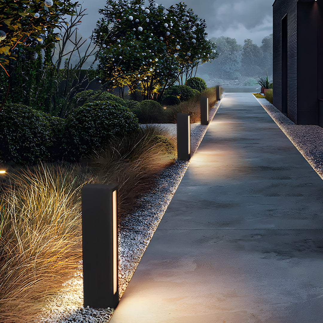 Landscape path accented by bright led wall light outdoor fixtures creating a soft guiding glow.