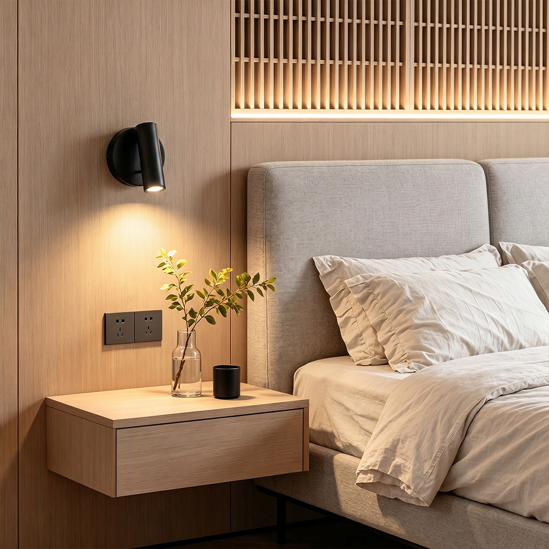 Modern LED wall reading light installed beside bed with warm focused lighting and wood panel backdrop.