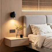 Modern LED wall reading light installed beside bed with warm focused lighting and wood panel backdrop.
