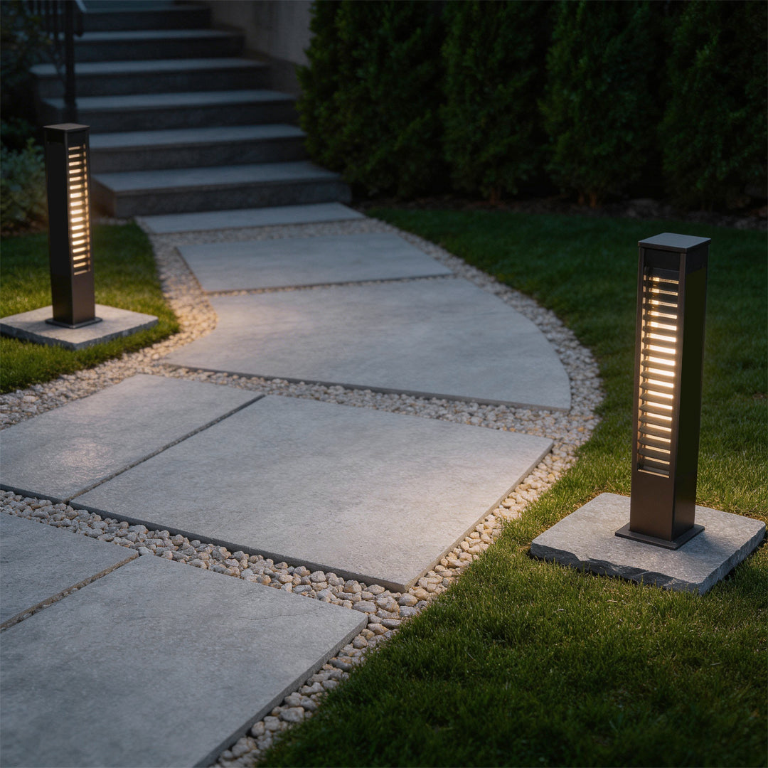 LED wall sconce outdoor bollard lights along walkway, sleek modern path lighting guiding steps at night.