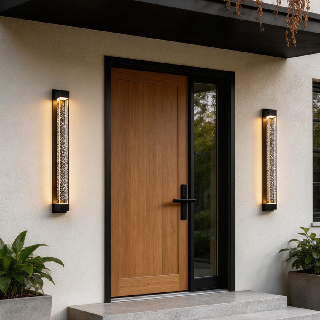 LED wall sconce outdoor flanking front door, contemporary long vertical lights with warm ambient glow.