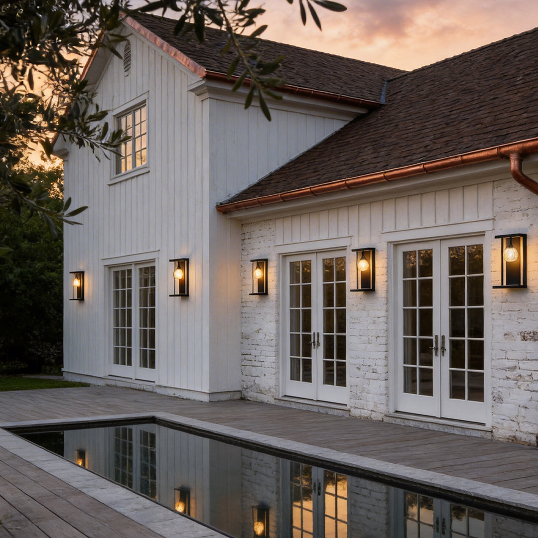 LED wall sconce outdoor outdoor wall mount light LED on house exterior, multiple fixtures creating warm ambient glow.