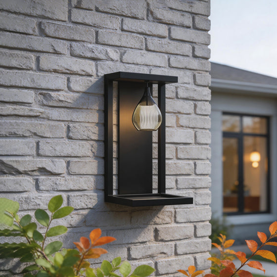 LED wall sconce outdoor outdoor wall mount light LED lantern style on brick wall with warm glowing bulb.