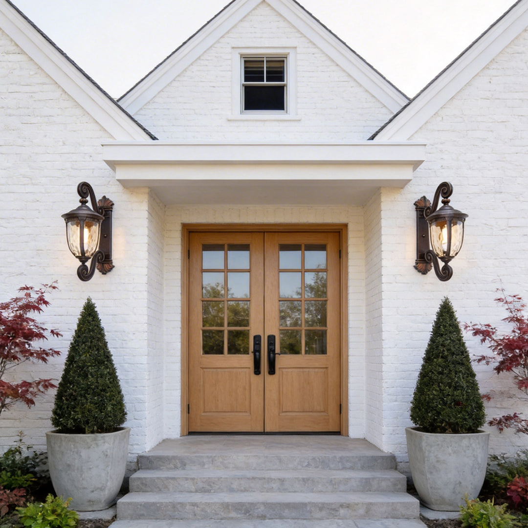 LED wall sconce outdoor lantern wall lights outdoor on house entrance, symmetrical fixtures framing doorway.