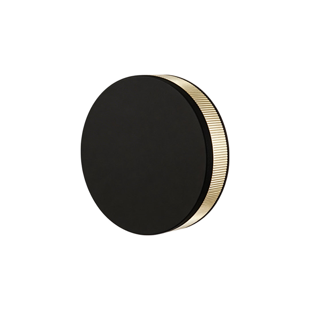 LED wall sconce outdoor mid-angle product shot, circular modern fixture with textured edge lighting.