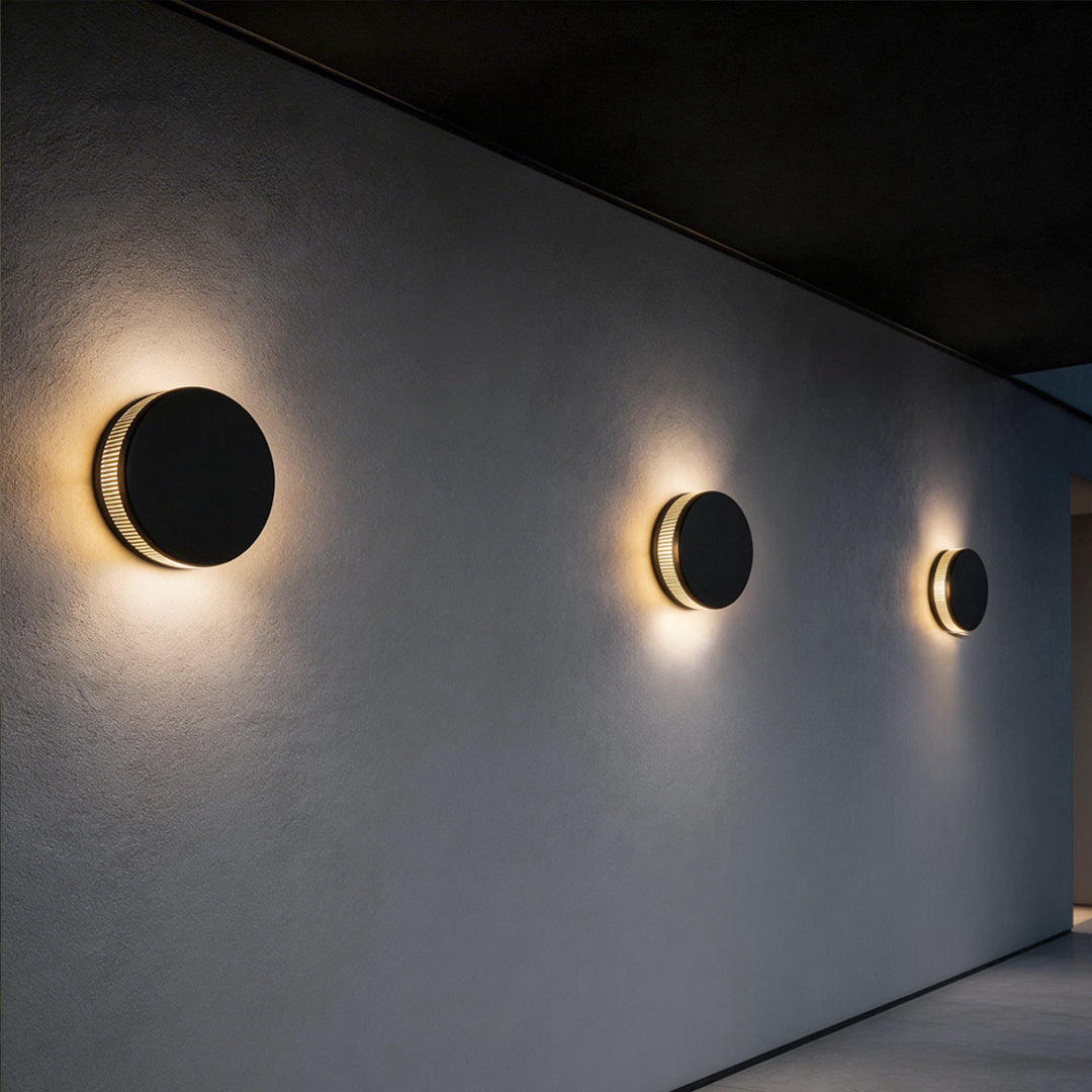 LED wall sconce outdoor multiple round fixtures aligned on wall, soft ambient lighting for modern exterior.