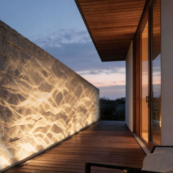LED wall sconce outdoor outdoor spotlight LED casting warm ripple light effect on exterior wall at night.