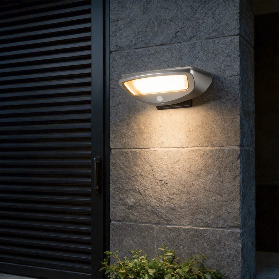LED wall sconce outdoor outdoor wall mounted solar lights on stone wall with warm ambient glow at night.