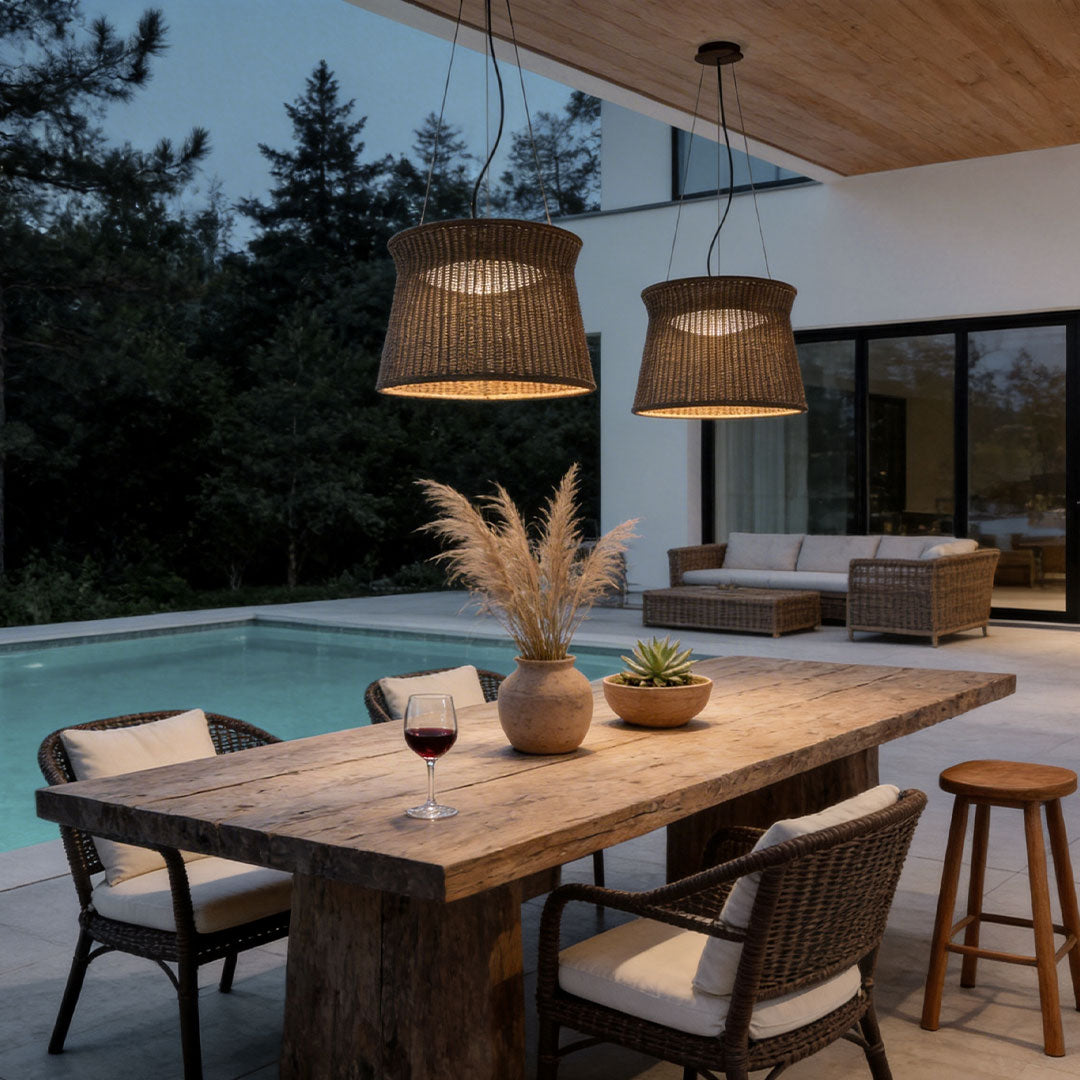 LED wall sconce outdoor woven light pendant above outdoor dining table near pool creating warm ambient lighting.