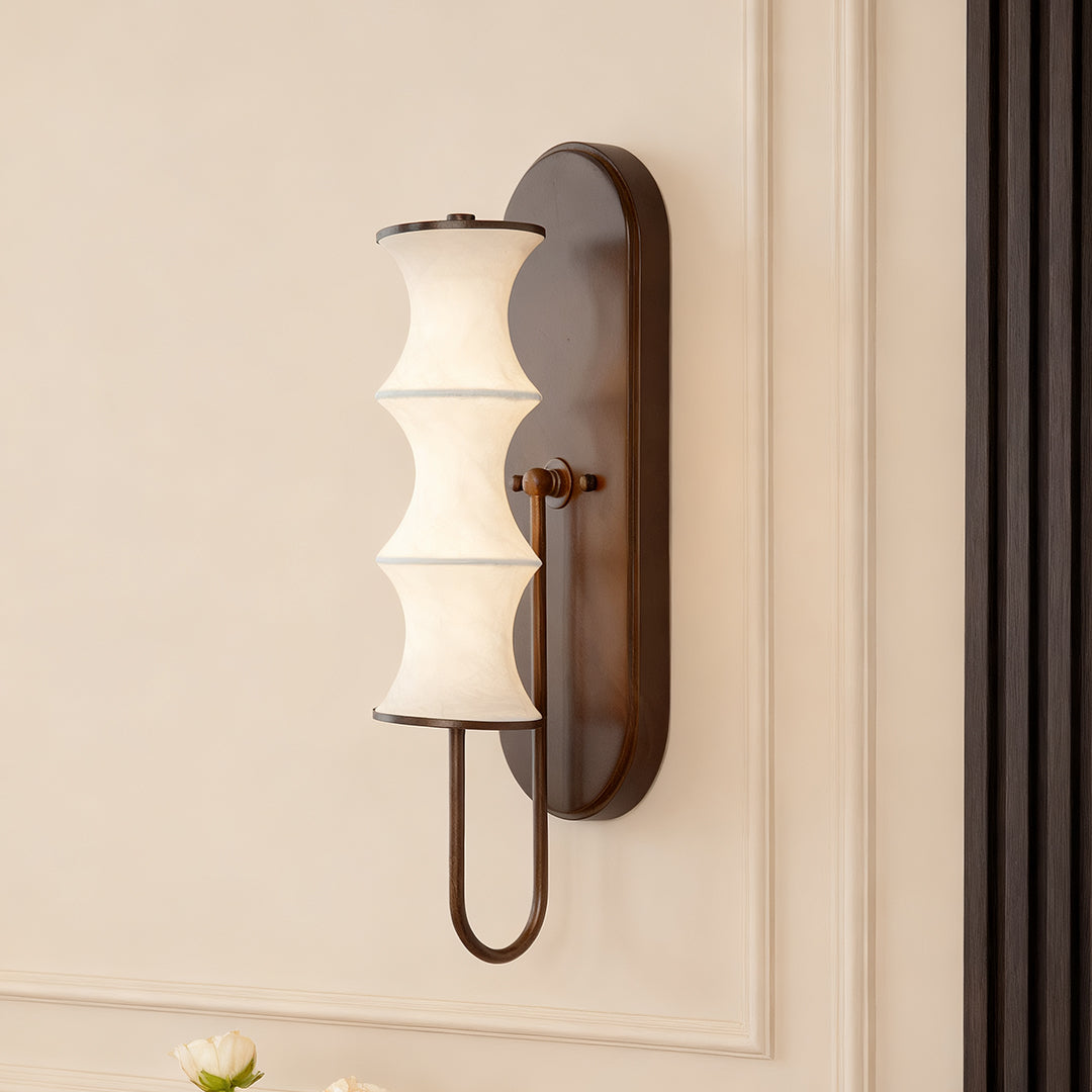 Elegant triple cylindrical vintage French wall lights with white glass shades in a minimalist interior