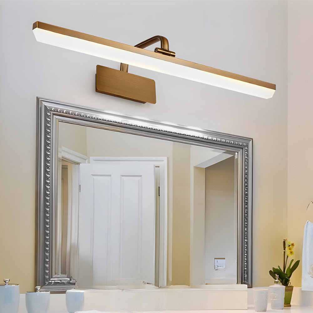 Light bar vanity with a close-up of its elegant gold frame and warm light.