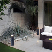 Light bollard installed beside modern outdoor stairs, adding soft pathway illumination.