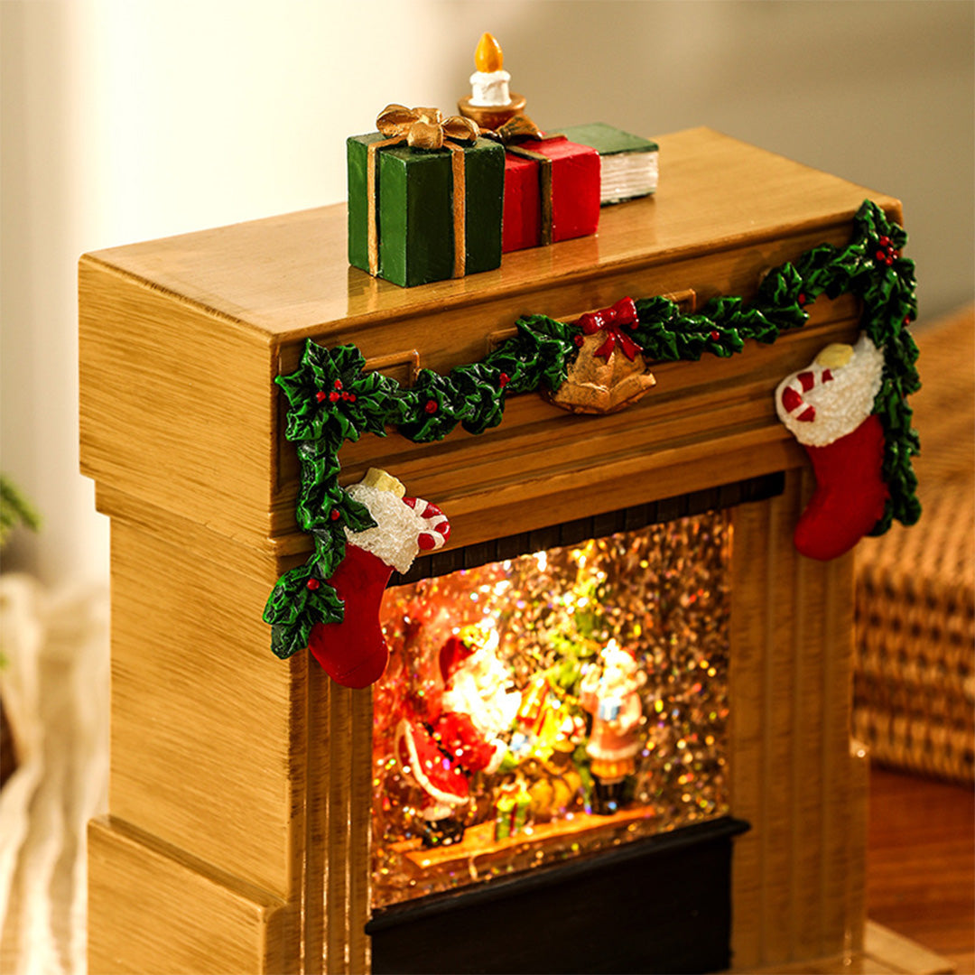 close-up view of a light up christmas fireplace ornament with illuminated festive scene