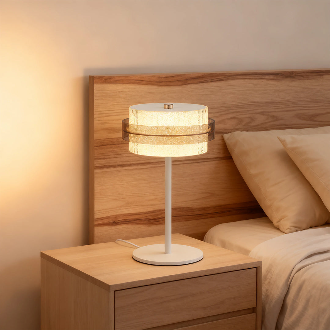 Light wood nightstand featuring a white vintage metal table lamp style with an illuminated crystal ring.