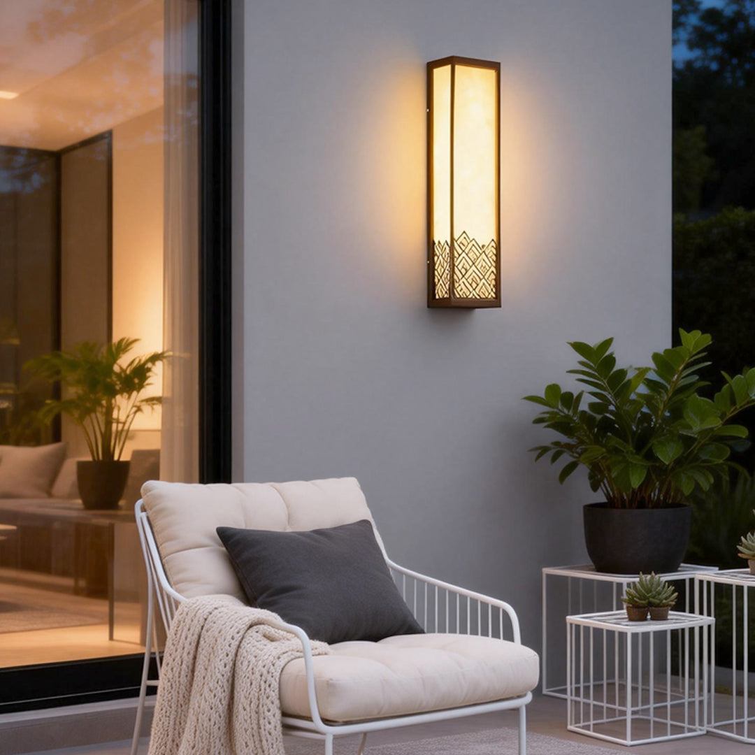 Lightbox wall lamp illuminating a modern balcony with warm, ambient glow.