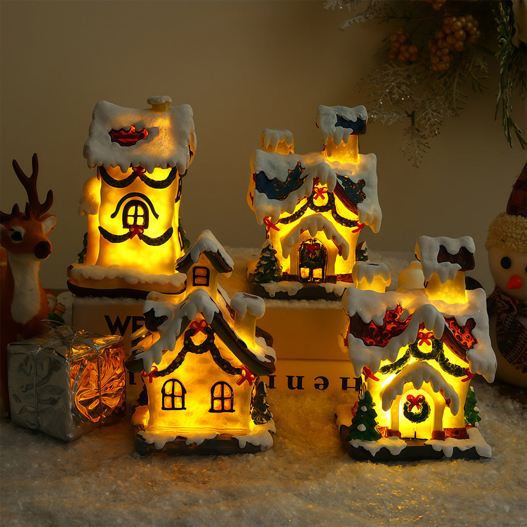 Lighted ceramic Christmas village house with snowy roof and warm yellow lighting.