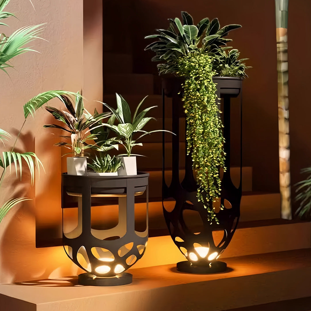 Using a tall and short lighted outdoor planter set to display greenery and provide warm light on a staircase.