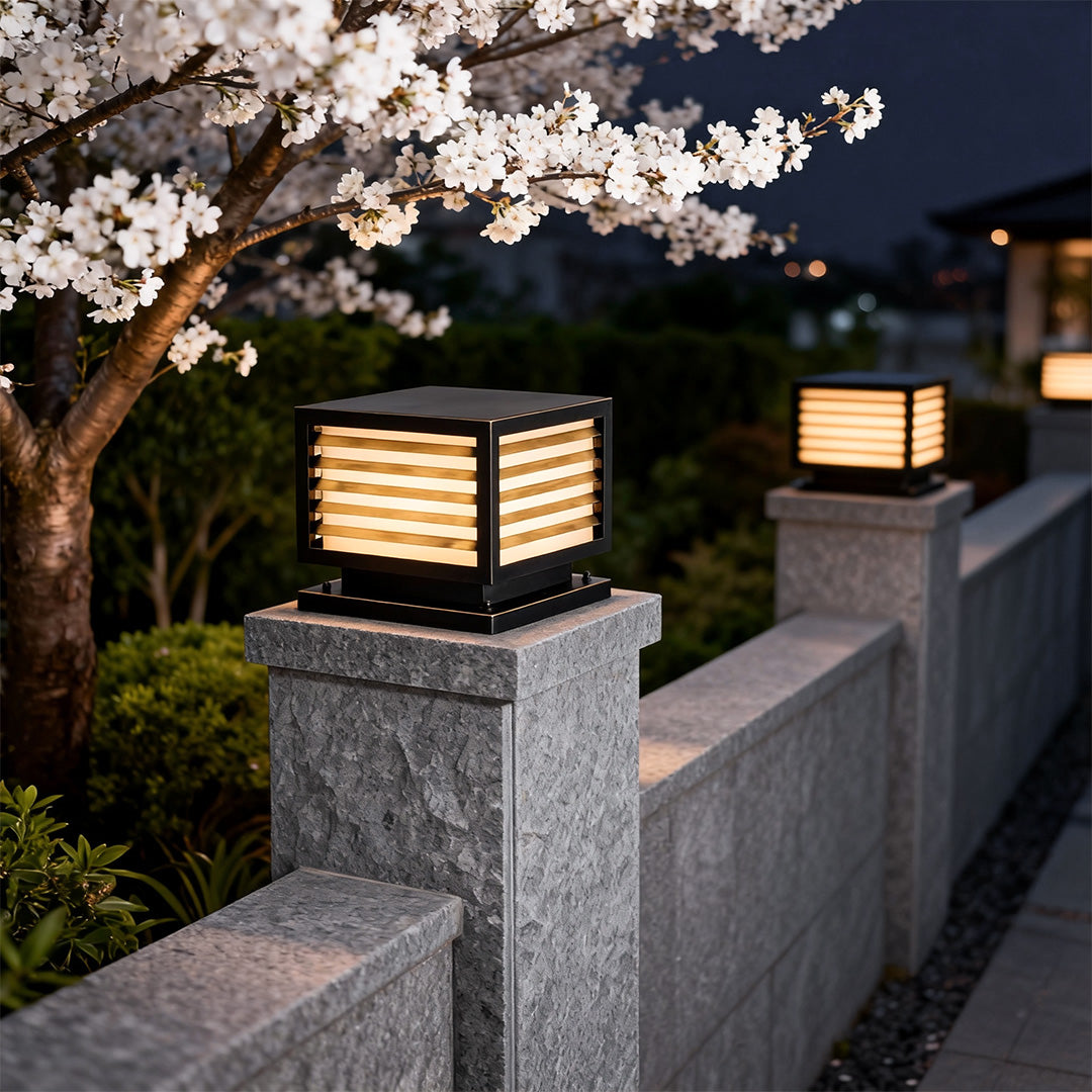 Lights for pillar creating a cozy atmosphere on a stone pillar, surrounded by blooming cherry blossoms.