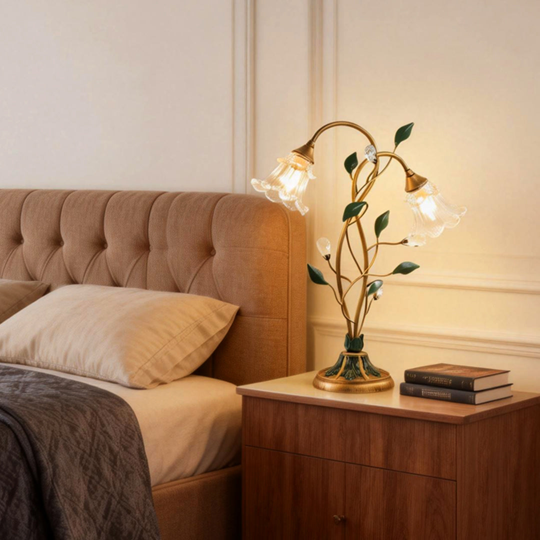 Lily table lamp providing soft light beside a modern bed setup.