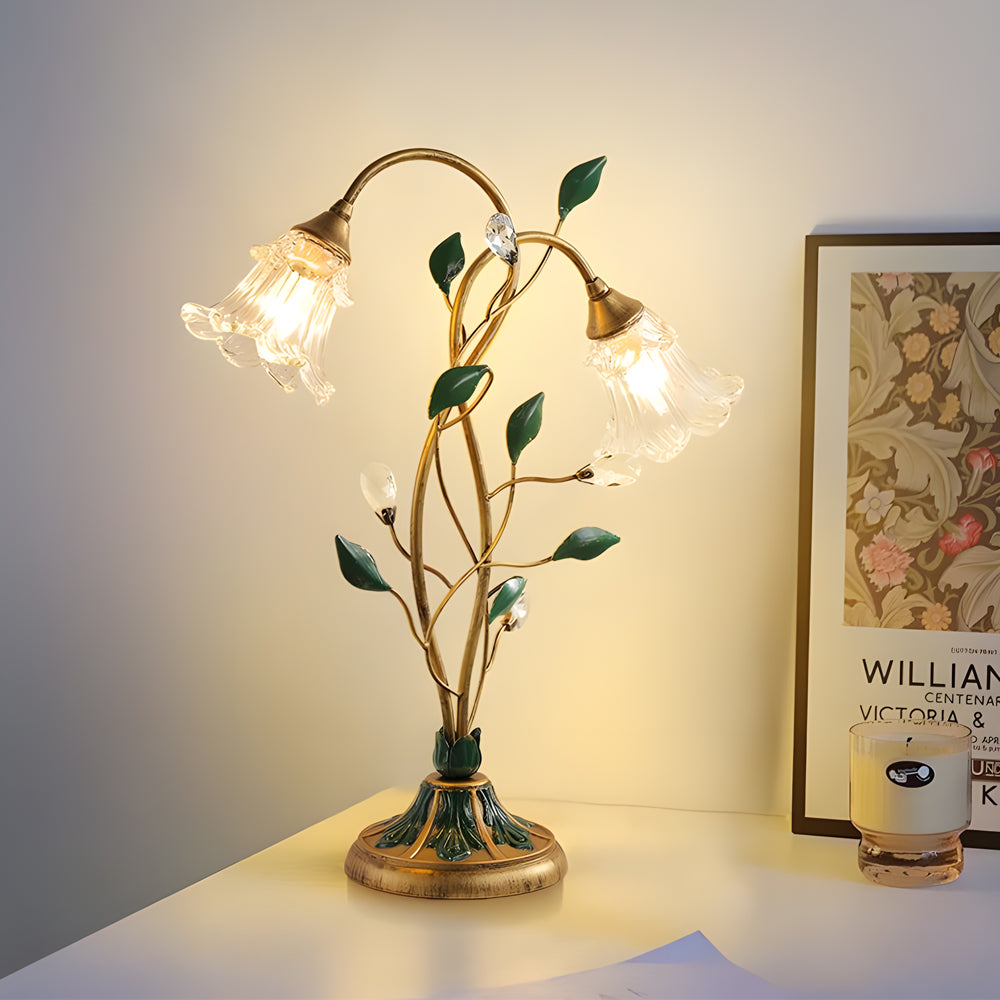 Lily table lamp illuminating a stylish desk with warm, ambient light.