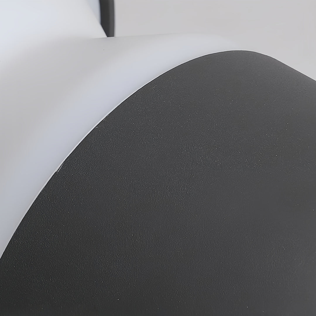 Line of low-profile modern path lights bordering a large, square paver walkway in a contemporary landscape design.