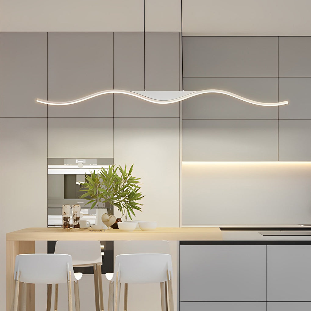 A modern line wave pendant light illuminating the kitchen area with soft, even light, enhancing the clean and elegant interior design.