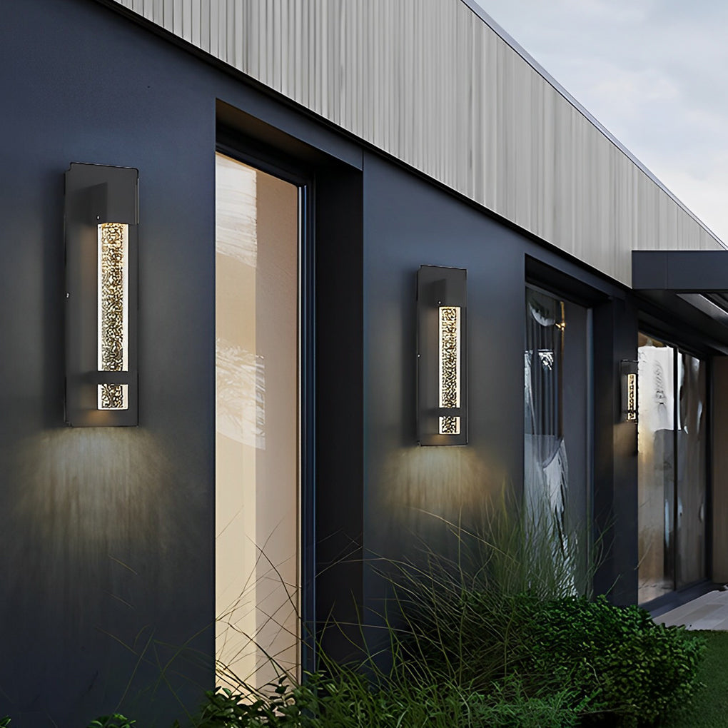 Linear bubble wall sconce installed on modern exterior wall, adding warm decorative lighting along walkway.