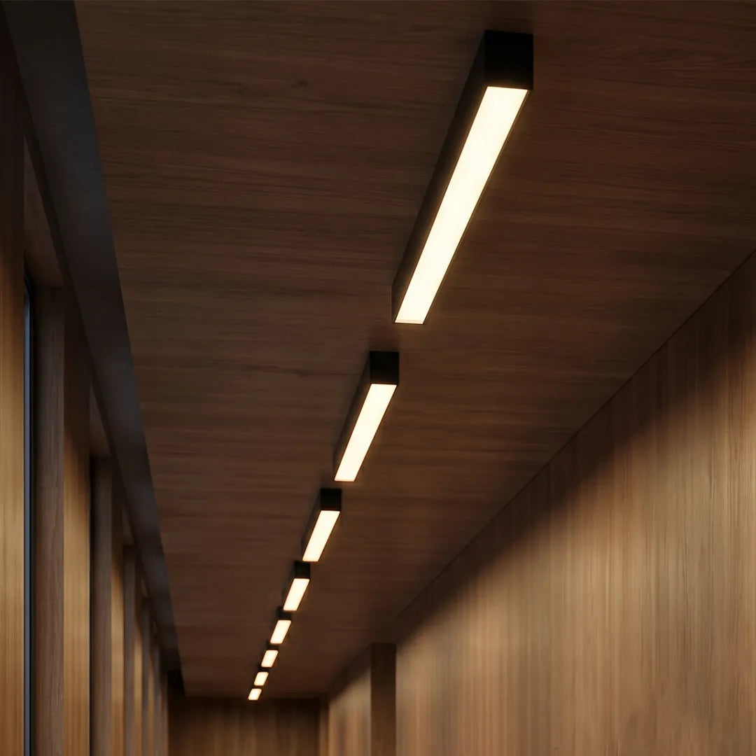 Linear ceiling light arranged in a row on a wood ceiling hallway, creating a refined and continuous lighting effect.