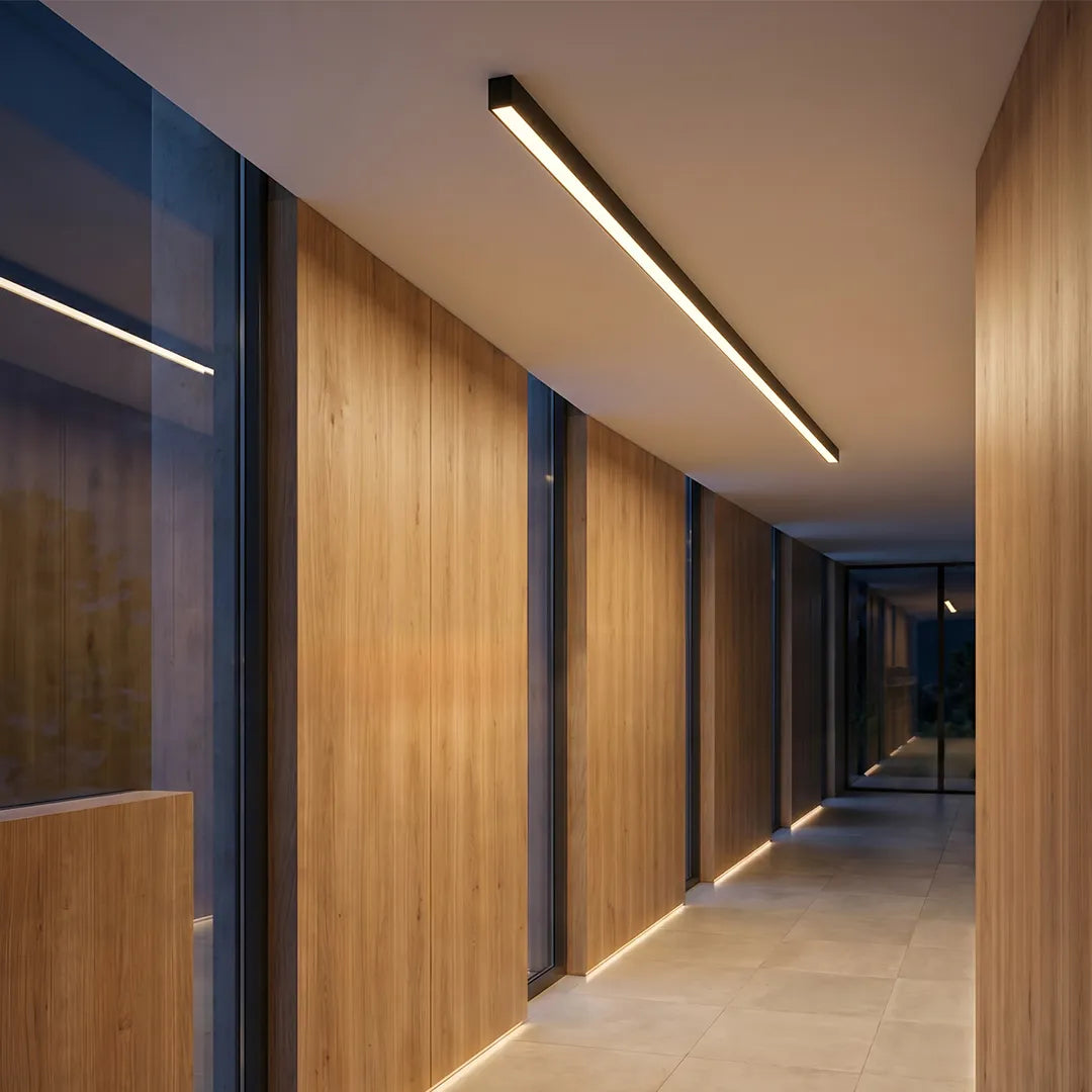 Linear ceiling light used in a contemporary corridor with wood wall panels, adding streamlined architectural lighting to the passageway.