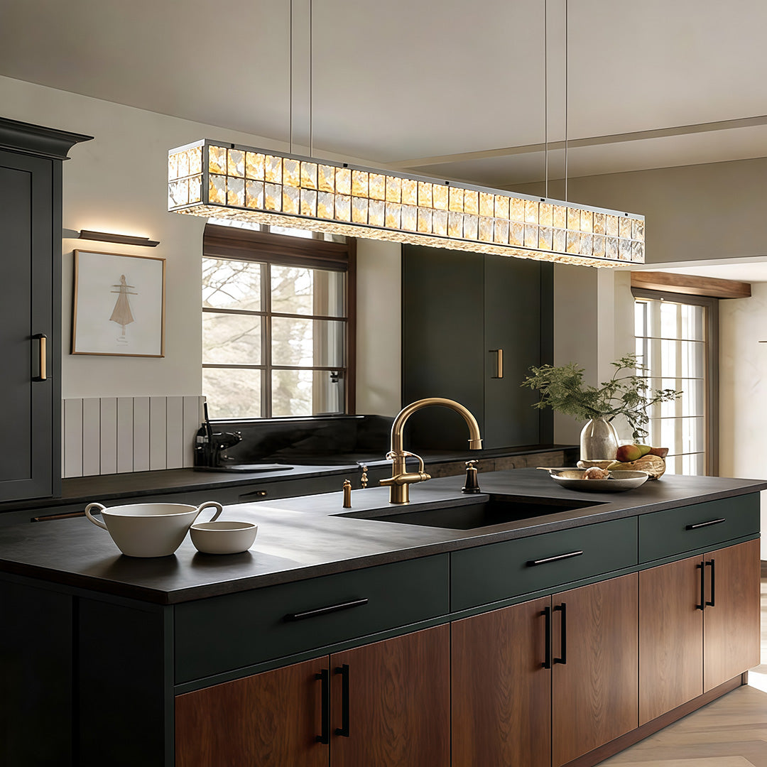 Linear crystal light adding elegance to a contemporary kitchen with dark wood cabinets and a large island.