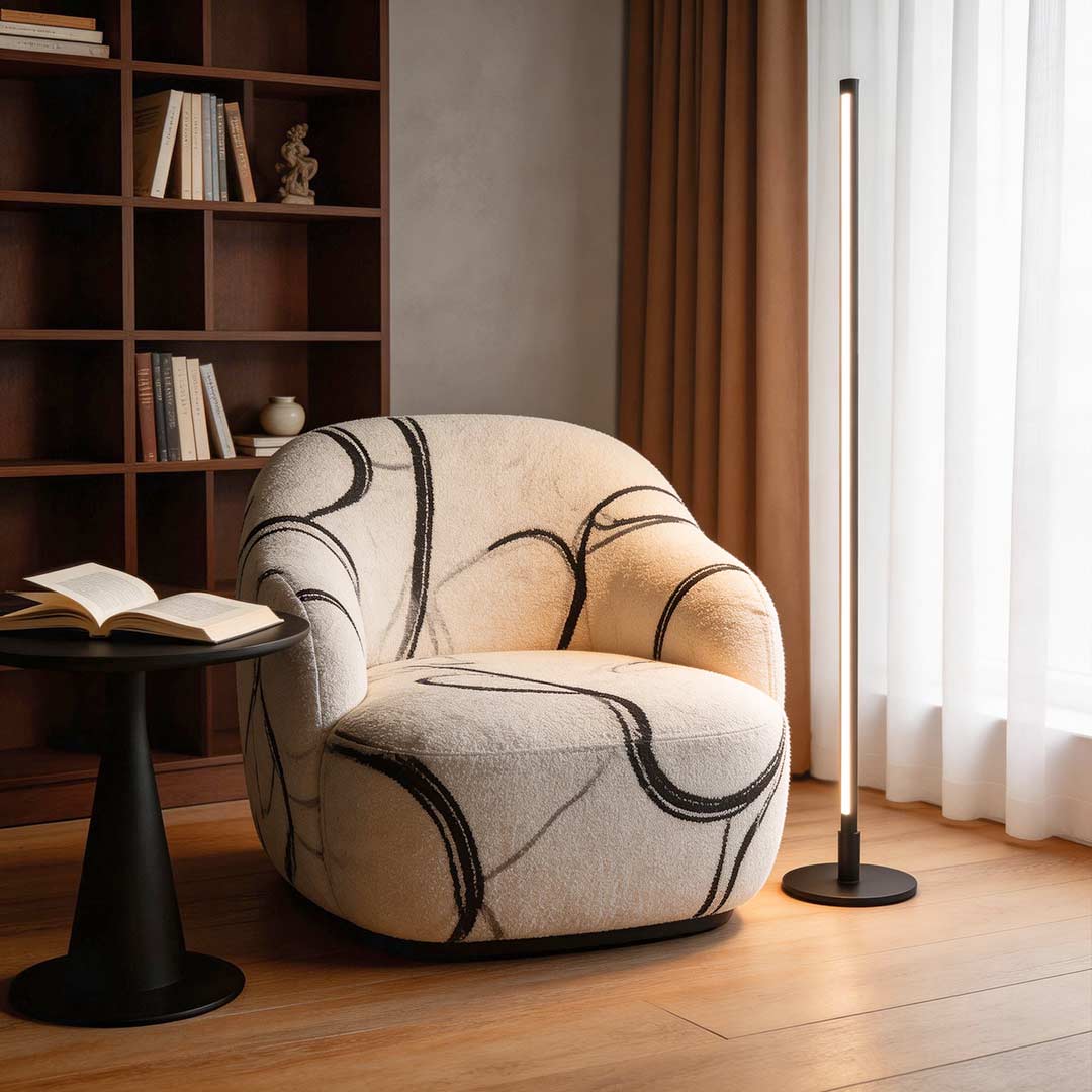 Linear floor lamp enhancing a stylish reading nook with elegant directional light.