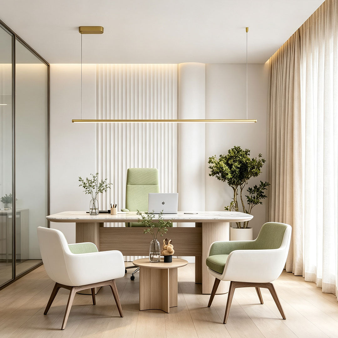 Linear gold pendant light suspended above a modern executive office seating area.