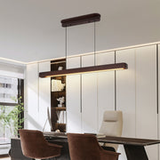 Elegant linear LED pendant lighting hanging above dining table, combining functionality and modern design.