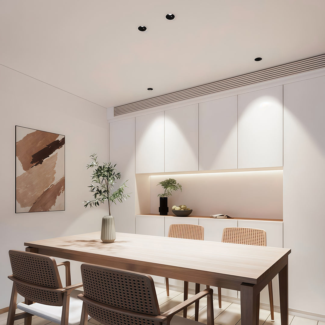 Linear LED recessed spotlights illuminating modern dining area with white chairs and minimalist decor