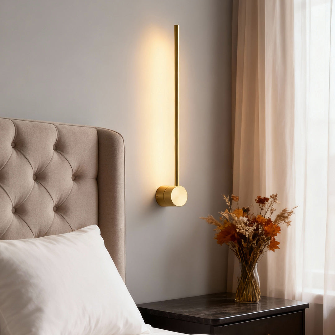 Linear LED wall light installed beside bedroom headboard