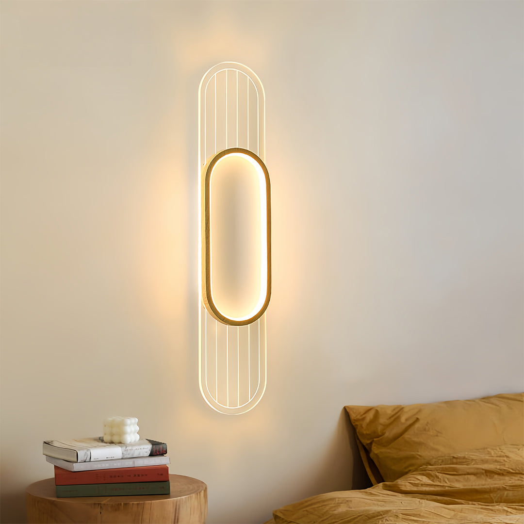 Linear led wall light illuminating bedroom with warm ambient glow beside wooden headboard and neutral bedding