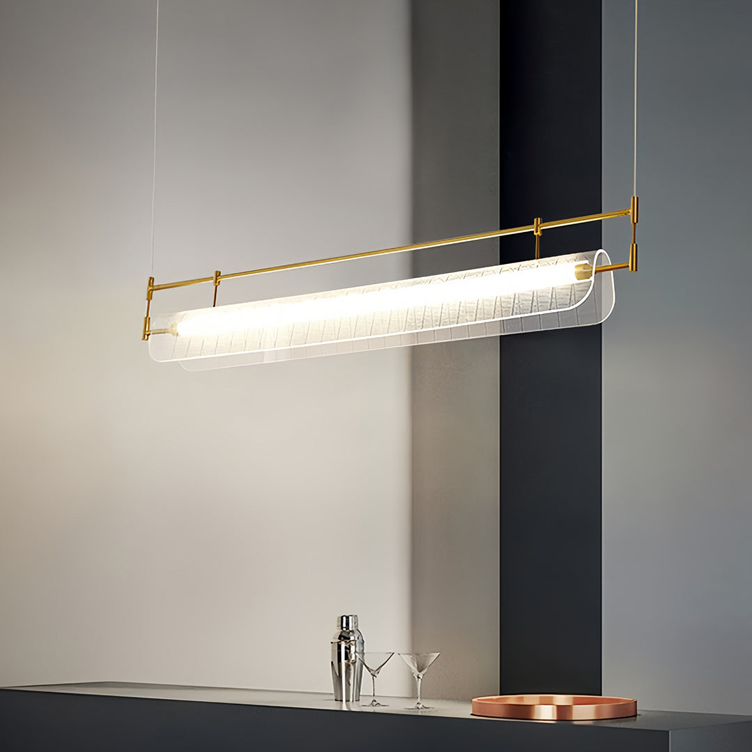 Linear light pendant illuminating contemporary kitchen with dark grey and white contrast interior.