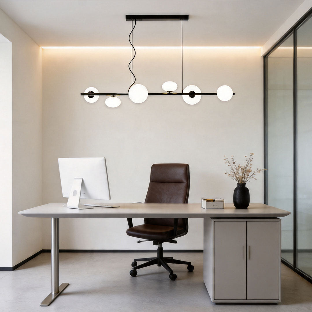 Linear modern chandelier in a contemporary office workspace with clean lines and soft ambient lighting.