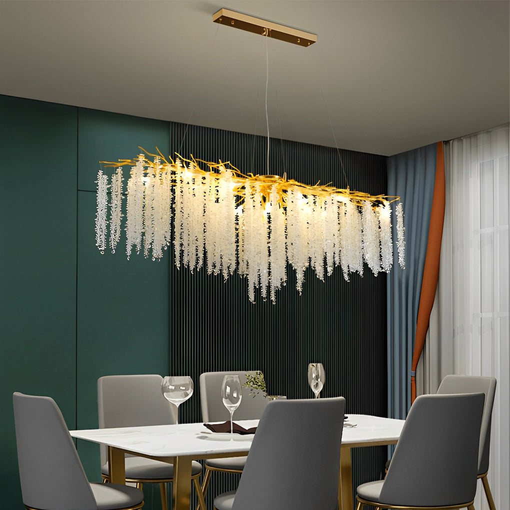 Linear modern gold crystal chandelier suspended elegantly above a stylish dining room table.