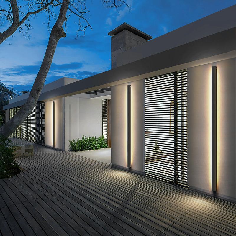 Linear outdoor wall sconce providing ambient lighting, installed beside a large glass window for stylish outdoor decor.